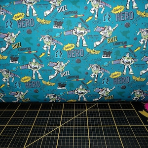 Camelot Fabrics. Disney/Pixar Toy Story III. Buzz Action Blue - Buzz Lightyear Fabric