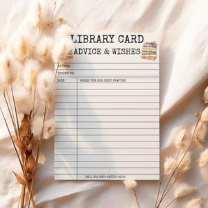 May include: A white library card with the text "LIBRARY CARD ADVICE & WISHES" and lines for writing. The card has a watercolor illustration of books and space for author, date, and wishes. Dried flowers are in the background.
