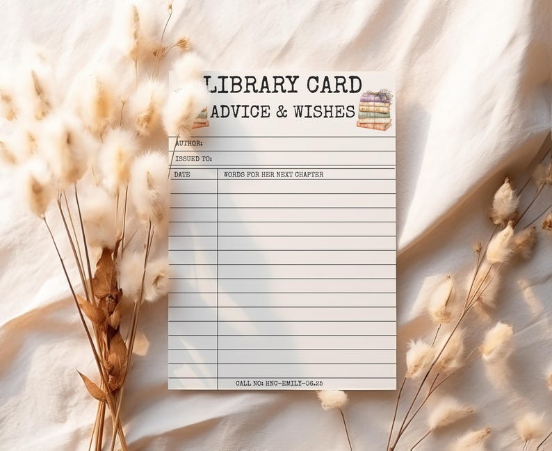 May include: A white library card with the text "LIBRARY CARD ADVICE & WISHES" and lines for writing. The card has a watercolor illustration of books and space for author, date, and wishes. Dried flowers are in the background.