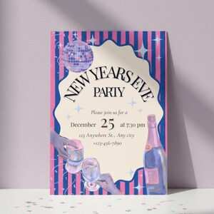 May include: A New Year's Eve party invitation with a pink and blue color scheme. The design includes a disco ball, champagne bottle, and glasses. The text reads "New Years Eve Party" and includes the date, time, and location.