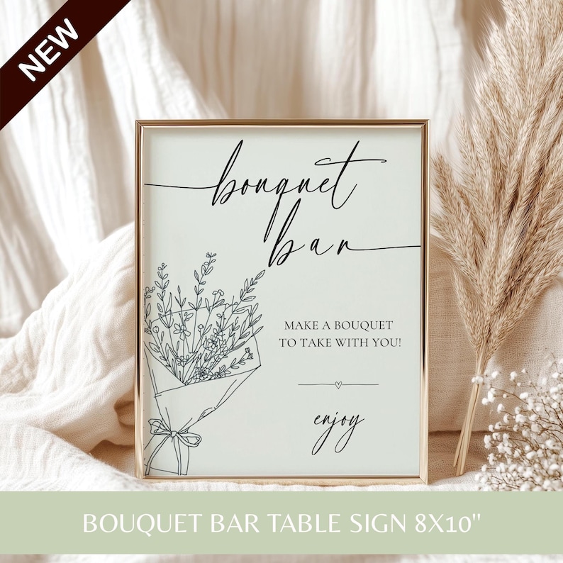 A gold-framed table sign reading Bouquet Bar Make a bouquet to take with you with a floral illustration.