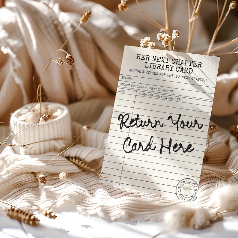 May include: A rectangular off-white library card with black text reading Her Next Chapter Library Card, Advice & Wishes for Emily's Next Chapter, Booked for Love, and Return Your Card Here, featuring a circular stamp with a bow icon at the bottom.