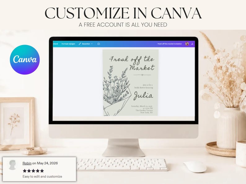 A computer monitor displaying a bridal shower invitation template in Canva with a decorative vase and flowers on the desk.