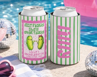 May include: Two cylindrical can coolers featuring a vertical green and white striped pattern. One cooler displays a pink scalloped frame with two cartoon pickles, text reading "Last Pickle She'll Ever Tickle" and "Lilly's Bachelorette Charleston 2026". The other shows the name "Lilly" in large pink letters.