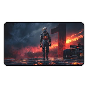 May include: A rectangular desk mat featuring a racing driver in a dark blue Red Bull racing suit and helmet walking toward the viewer. A large number one stands in the background next to a Formula One car against a fiery orange and dark sky.