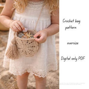 May include: A beige crochet bag with a tassel and a strap, filled with seashells. The bag has an openwork design and is held by a person wearing a white dress. The text on the right says "Crochet bag pattern, oversize, Digital only PDF."