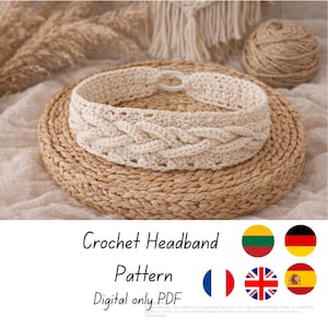 May include: A cream-coloured crochet headband with a braided design, resting on a woven mat. The text "Crochet Headband Pattern Digital only PDF" is displayed below the headband. A ball of yarn is in the background.