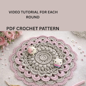 May include: A crocheted doily in gray and pink, with a circular design and scalloped edges. The text "INSTANT DOWNLOAD ADJUSTABLE SIZE" and "VIDEO TUTORIAL FOR EACH ROUND PDF CROCHET PATTERN" is visible. Two small animal figurines are on the doily.