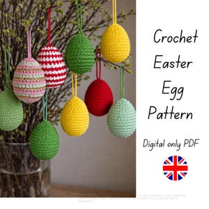 May include: Crocheted Easter eggs in various colors, including green, yellow, red, and pink, hang from branches. The eggs are suspended by colorful strings. The image includes the text "Crochet Easter Egg Pattern" and "Digital only PDF".
