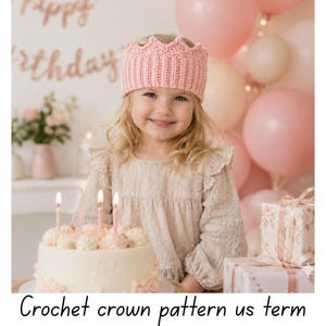 May include: A child wearing a pink crocheted crown smiles in front of a birthday cake and presents. Pink balloons fill the background, with "Happy Birthday" written above. The text "Crochet crown pattern us term" is at the bottom.