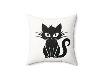 May include: Square white pillow featuring a black cat illustration. The cat is sitting upright with a curved tail, whiskers, and large eyes. The design is simple and graphic, suitable for home decor.