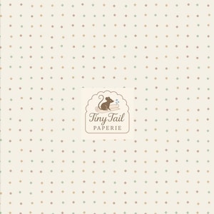 May include: Off-white fabric with a repeating pattern of small, evenly spaced dots in muted shades of brown, green, and blue. The Tiny Tail Paperie logo is in the lower right corner, featuring a mouse and the brand name.