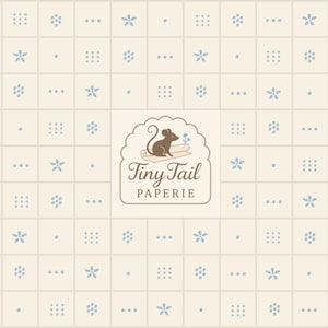 May include: Cream-coloured patterned paper with a grid design. The pattern includes small blue floral and dot motifs, along with clusters of three dots and small squares. The centre features a logo with a mouse and the text "Tiny Tail PAPERIE."