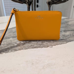 bright yellow coach backpack Refined pebble leather Inside zip and multifunction pockets Double zip closure fabric lining Handle with 2 1/4 drop Outside zip pocket Adjustable shoulder straps 10 3/4 (L) x 12 1/2 (H) x 4 3/4 (W) Style No. Bright yellow backpack with brown