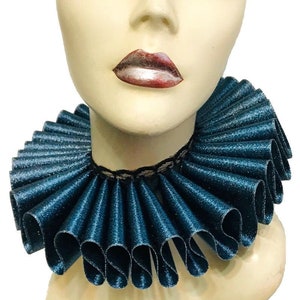 May include: A teal blue ruffled collar with a black lace trim. The collar is made of satin and has a shimmery finish.