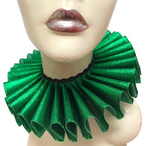 May include: A green ruffled collar made of satin with a sparkly finish. The collar is worn on a mannequin's neck.