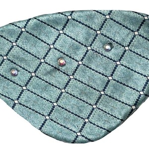 May include: A teal blue fabric face mask with a geometric pattern and rhinestones.