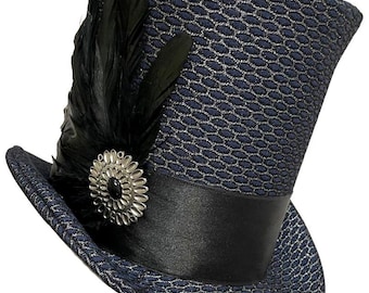 May include: A navy blue top hat with a textured pattern and a black satin band. The hat is adorned with a cluster of black feathers and a silver-toned decorative pin. The hat has a classic, formal design.