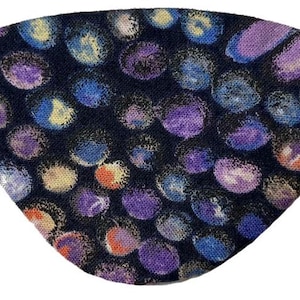 May include: A dark blue eye mask with a repeating pattern of colorful, abstract shapes. The shapes are primarily purple, blue, yellow, and orange, with a black elastic band for securing the mask.