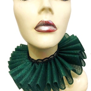 May include: A green ruffled collar with a black lace trim. The collar is made of a sparkly fabric and is perfect for adding a touch of elegance to any outfit.