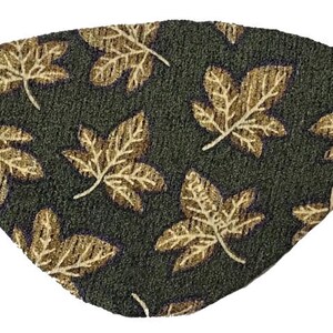 May include: A green eye patch with a pattern of gold leaves. The eye patch has elastic straps on either side.
