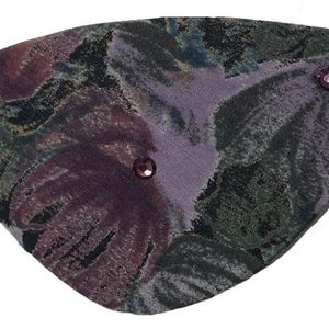 May include: A purple and green floral eye patch with two small purple rhinestones.