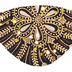 May include: A black eye patch with a gold and brown paisley design and gold sequins.