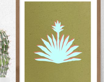 May include: A framed wall art print featuring a light blue agave plant illustration with a coral red shadow effect, set against a textured olive green background. The artwork is enclosed in a simple, light brown wooden frame with a white mat border.