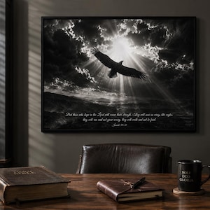May include: A black and white framed wall art print featuring an eagle soaring through a cloudy sky with sun rays. The text reads: But those who hope in the Lord will renew their strength. They will soar on wings like eagles; they will run and not grow weary, they will walk and not be faint. Isaiah 40:31.