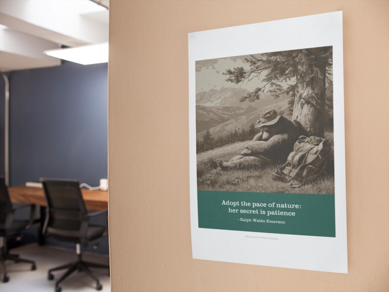 May include: A framed print featuring a sepia-toned illustration of a person resting under a tree, with a backpack nearby. The print includes the quote "Adopt the pace of nature: her secret is patience" by Ralph Waldo Emerson.