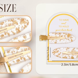 May include: Two white and gold hair clips with a gold clasp. The clips are 5.8cm long and 1.7cm wide. The text on the card reads "TO HAVE and TO HOLD your hair back."