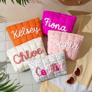 May include: Five quilted pouches in vibrant colours: orange, fuchsia, cream, light pink, and a floral pattern. Each pouch features an embroidered name: Kelsey, Fiona, Chloe, Sophia, and Cecilia. Heart-shaped sunglasses are also visible.