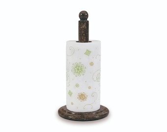 May include: A decorative paper towel holder with a brown marble base and a matching vertical post topped with a small sphere. The paper towel roll is white with green and gold floral patterns.