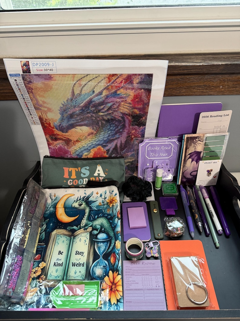 Peut inclure: Un ensemble de papeterie et d'artisanat comprenant un kit de broderie diamant dragon avec le texte DP2009-J, une trousse avec le texte IT'S A GOOD DAY, un livre illustr&eacute; d'un dragon avec le texte Be Stay Kind Weird, des stylos et des notes.