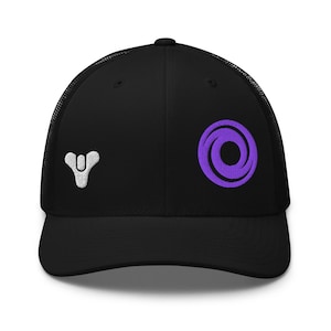 May include: A black trucker cap featuring a white embroidered Destiny logo on the left side and a purple embroidered circular swirl emblem on the right side. The cap has a structured front panel and a mesh back for ventilation.