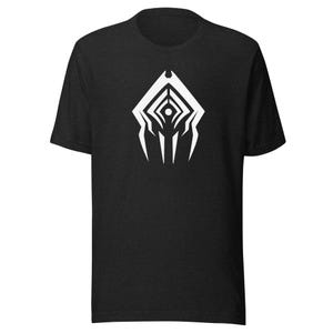 May include: A black short-sleeved t-shirt featuring a centered white graphic print. The design consists of a symmetrical, angular, shield-like emblem with sharp points and a small circular dot at the center, positioned on the chest area.