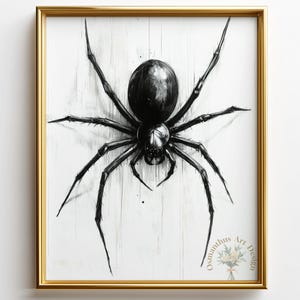 May include: A framed art print featuring a detailed black spider illustration against a white background. The spider is centered, with its legs extended. The artwork is in a gold frame, with the artist's name in the bottom right corner.
