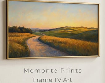 May include: A framed landscape painting with a golden frame. The artwork depicts a winding road through a field of golden wheat, leading towards rolling green hills under a sunset sky. The text "Memonte Prints Frame TV Art" is displayed below the painting.