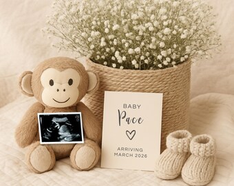 May include: A plush monkey holding an ultrasound image, next to a card that reads "BABY Pace" and "ARRIVING MARCH 2026". A pair of knitted baby booties and a basket of white flowers complete the scene.