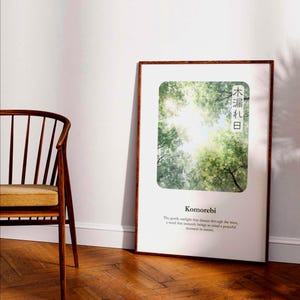 May include: A framed art print depicting sunlight filtering through green tree leaves. The print includes the Japanese word "Komorebi" and the text "The gentle sunlight that dances through the trees, a word that instantly brings to mind a peaceful moment in nature."