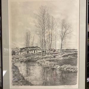 May include: Framed black and white landscape print featuring a rural scene with a river, trees, and a small building. The artwork is signed and numbered 25/300. The print is in a gray frame.