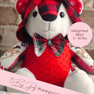 May include: A white plush bear with a red and black plaid hood and bow tie. The bear has a red body with small black hearts. The arms have a patterned design. The text on the image says "Weighted Bear 5-10 lbs" and "Big Pig Keepsake Bear".
