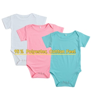 May include: Three baby bodysuits in white, pink, and turquoise. The short-sleeved onesies have a round neckline and snap closures at the bottom. The text "95% Polyester, Cotton Feel" is displayed across the image.
