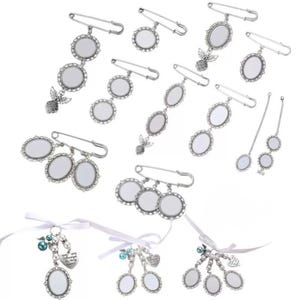 May include: A selection of silver-coloured brooches and charms with oval frames. Some brooches have multiple frames, while others feature angel or heart-shaped embellishments. White ribbons and beads are also included.