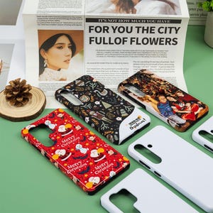 May include: A collection of phone cases with various designs, including a red case with Santa Claus and the text "Merry Christmas". Other cases feature patterns and a photo. The cases are displayed on a green surface.