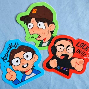 May include: Three colorful stickers featuring cartoon illustrations of men. One sticker has the text "Actually," another says "LOCK IN!!!" and the third says "melp." The stickers are outlined in green, blue, and red.