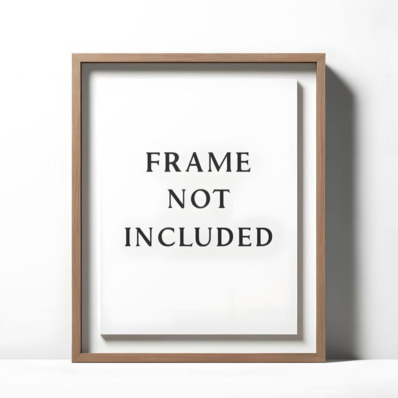 May include: A rectangular wooden frame with a white interior. The text "FRAME NOT INCLUDED" is centered on the white background in a bold, black font. The frame has a natural wood grain finish.