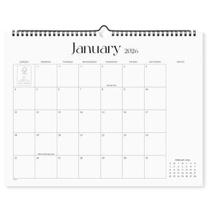 May include: A white wall calendar for January 2026, with a spiral binding at the top. The calendar grid is simple, with dates and days of the week clearly marked. The word "January" and the year "2026" are printed in a bold, elegant font.