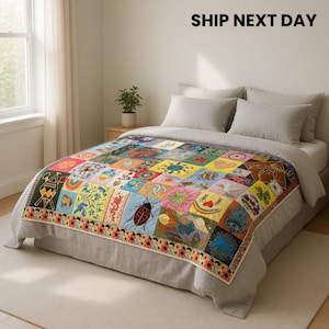 Puede incluir: Un edredón de retazos colorido con varios diseños cuadrados, incluyendo una mariquita, flores y formas geométricas. El edredón se muestra en una cama con ropa de cama gris. El texto "SHIP NEXT DAY" está en la parte superior.