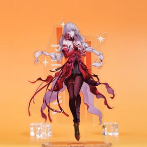 May include: A clear acrylic standee of a female anime character with silver hair and a red and black outfit. The character holds a flower and has flowing ribbons. The background is orange.